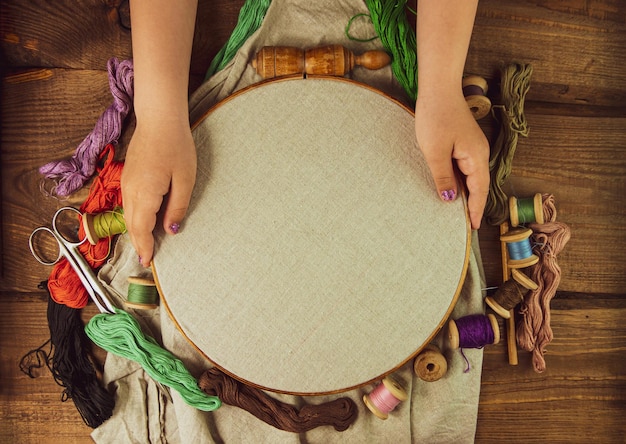 Hands doing embroidery hoop